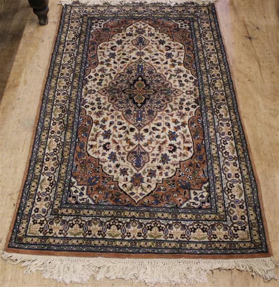 Persian pattern brown & ivory ground rug & a similar smaller rug